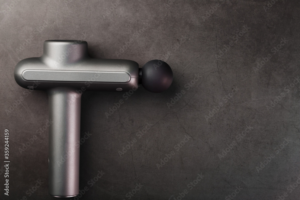 Massager for body massage on a black background. Massager for body massage on a black background.