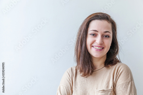 Happy girl smiling. Beauty portrait young happy positive laughing brunette woman on white background isolated. European woman. Positive human emotion facial expression body language
