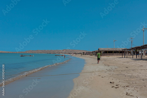 Man walks on the beach at Cabo de la vela  La guajira  Colombia