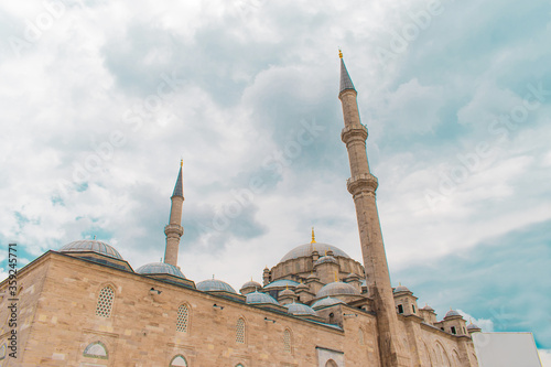 Fatih Mosque and Complex is a mosque and complex built by Fatih Sultan Mehmed in Fatih District of Istanbul. Mosque with blue sky behind it. photo