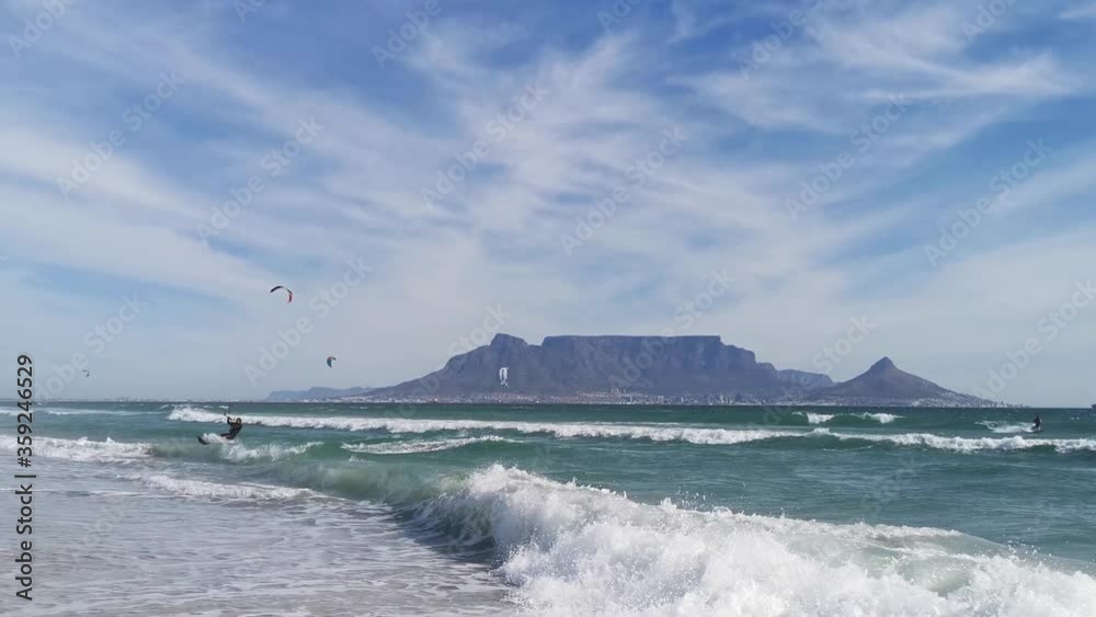 A kite boarder races to the beach and turns while aloft in Cape Town, South Africa A kite boarder races to the beach and turns while aloft in Cape Town, South Africa