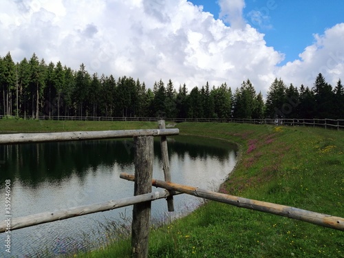 Slovenia, Pohorje, Areh, lake in the forest and wooden fence photo