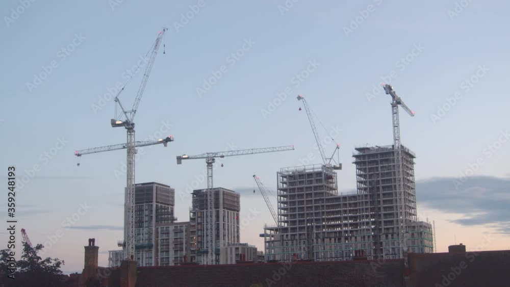 London modern city skyline and cityscape under construction with cranes and building work at beautiful sunset and evening London modern city skyline and cityscape under construction with cranes and building work at beautiful sunset and evening