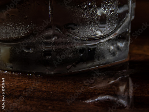 Cold water glass with droplets on it's body.