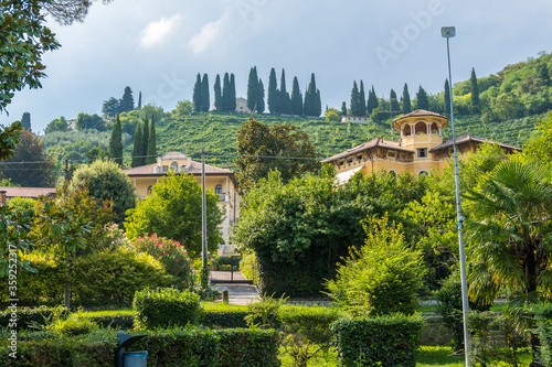 Valdobbiadene, Italy - August 11, 2019: Picturesque hills with vineyards of the Prosecco sparkling wine region and historic buildings in Valdobbiadene photo