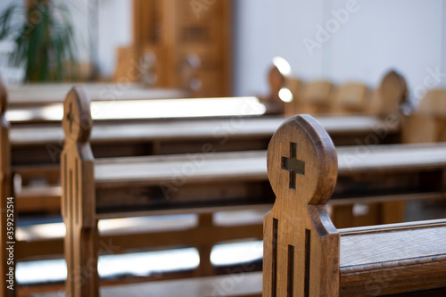 A close up view of a church bench without people.