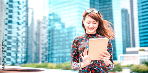 Photography Young asian woman using electronic device at modern city  - Technology lifestyle