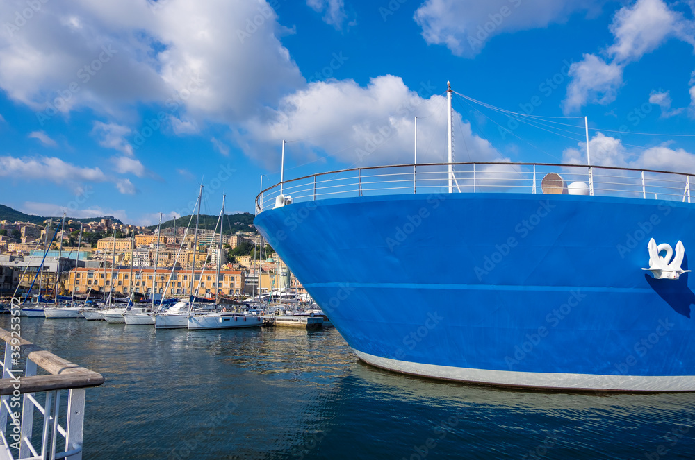 Genoa, Italy - August 18, 2019: Porto Antico di Genova or Old Port of Genoa and the cityscape in the background