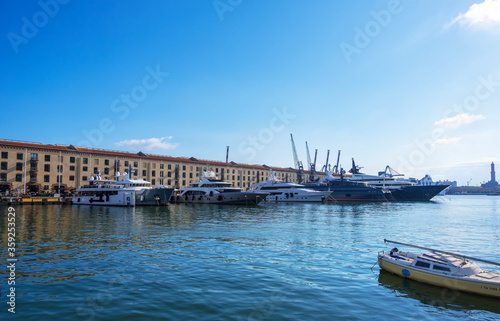 Genoa, Italy - August 18, 2019: Porto Antico di Genova or Old Port of Genoa and the cityscape in the background © kateafter