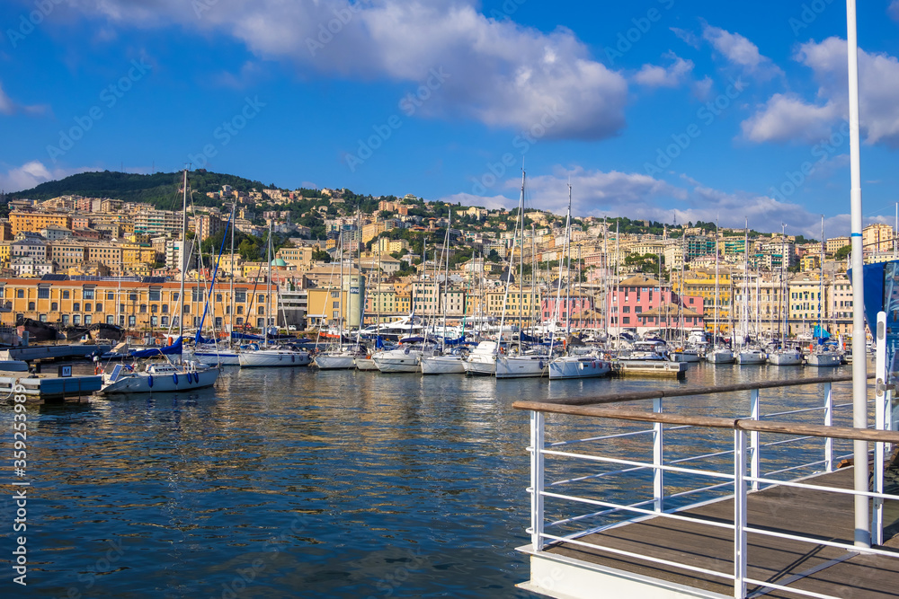 Genoa, Italy - August 18, 2019: Porto Antico di Genova or Old Port of Genoa and the cityscape in the background