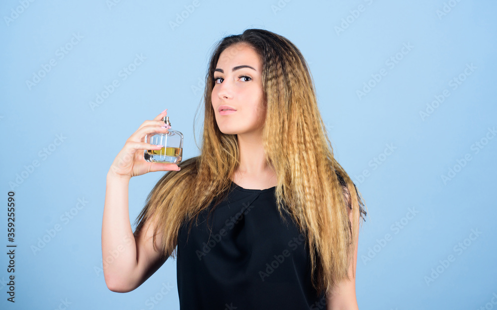Be impossible to forget. Girl applying perfume. Eau de Toilette. getting fresh. woman with bottle of perfume. beauty product. cosmetic care. scented water cologne in spray bottle Be impossible to forget. Girl applying perfume. Eau de Toilette. getting fresh. woman with bottle of perfume. beauty product. cosmetic care. scented water cologne in spray bottle