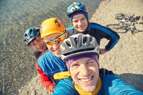 group of cyclists in helmets taking selfie photo. team outdoors. mountain bike.