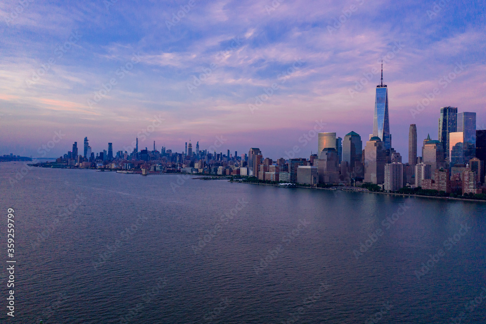 Aerial view of low Manhattan, new york at beautiful cloudy dusk from Hudson river