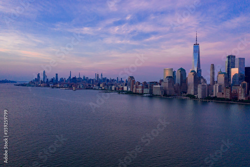 Aerial view of low Manhattan, new york at beautiful cloudy dusk from Hudson river