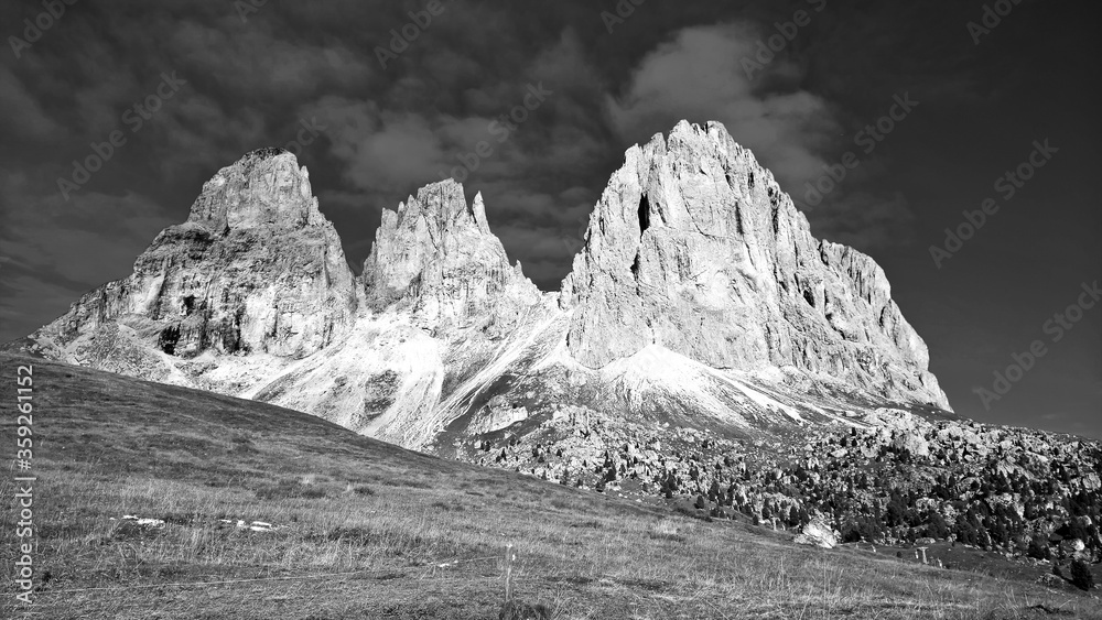 Trentino Alto - Adige, Italy - 06/15/2020: cenic alpine place with magical Dolomites mountains in background, amazing clouds and blue sky in Trentino Alto Adige region, Italy, Europe Trentino Alto - Adige, Italy - 06/15/2020: cenic alpine place with magical Dolomites mountains in background, amazing clouds and blue sky in Trentino Alto Adige region, Italy, Europe