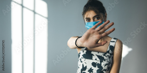 woman face mask hand stop sign