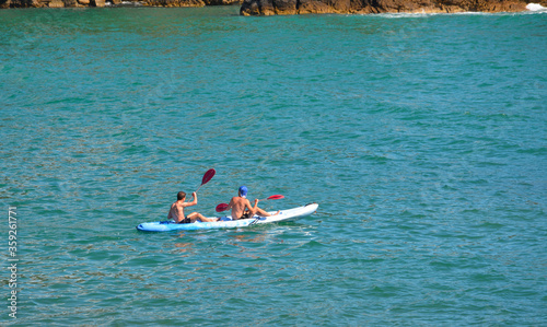 two young adults in canoe on the mediterranean sea