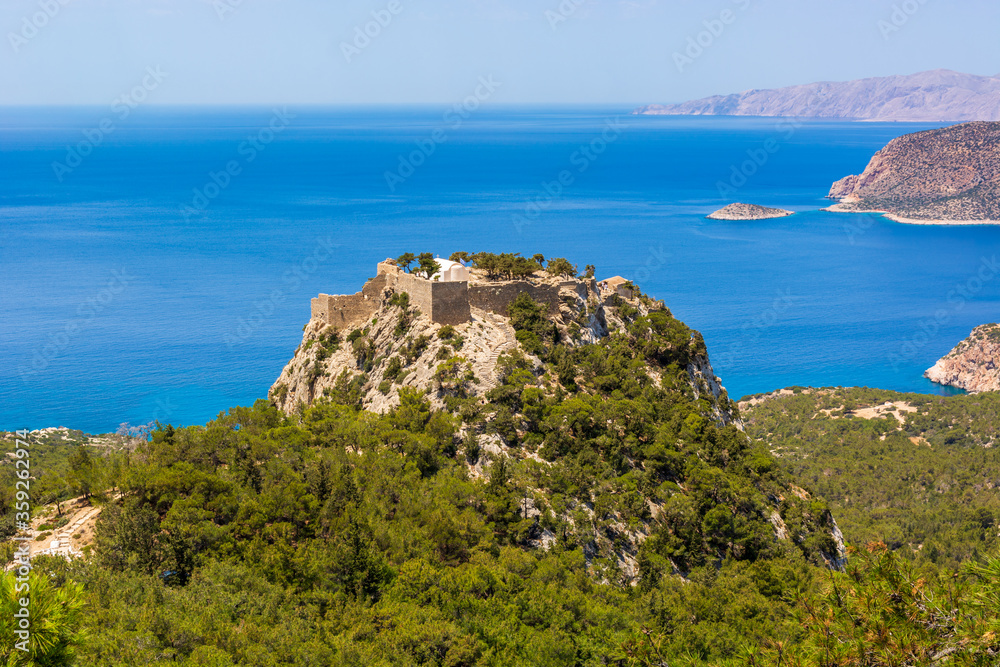 Obraz premium The castle of Monolithos located at the summit of the tall rock. Rhodes island, Greece
