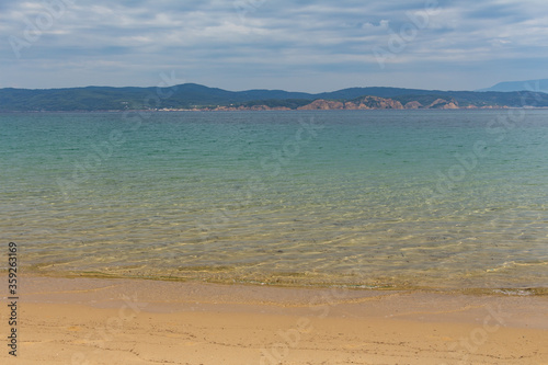 Obraz na płótnie Mandraki beach on Skiathos Island, Greece with its soft sand and crystal-clear water offers true enjoyment and relaxing day on the beach for its visitors w salonie