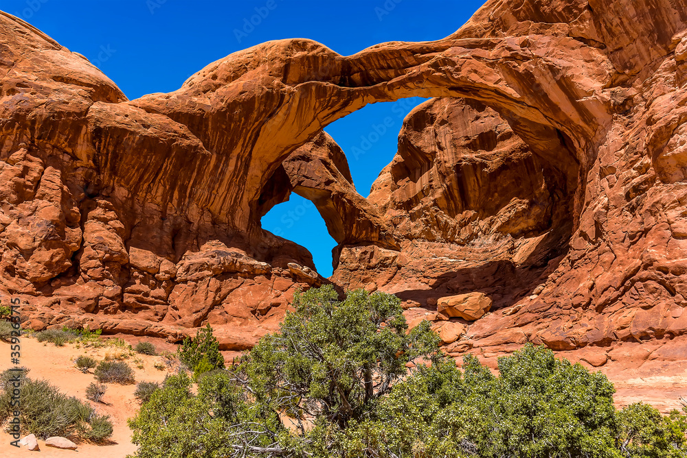 A view of Double Arch showing desert varnish in Arches National Park, Moab, Utah in springtime