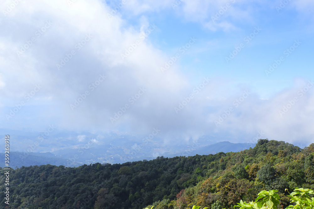 Mountain landscape, with mountain peaks covered with forest and a big cloudy sky. Chiang Mai, Thailand