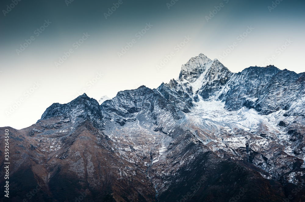 Himalaya mountain range against the blue sky at sunrise. Thamserku peak. Khumbu valley, Himalayas, Everest region, Nepal