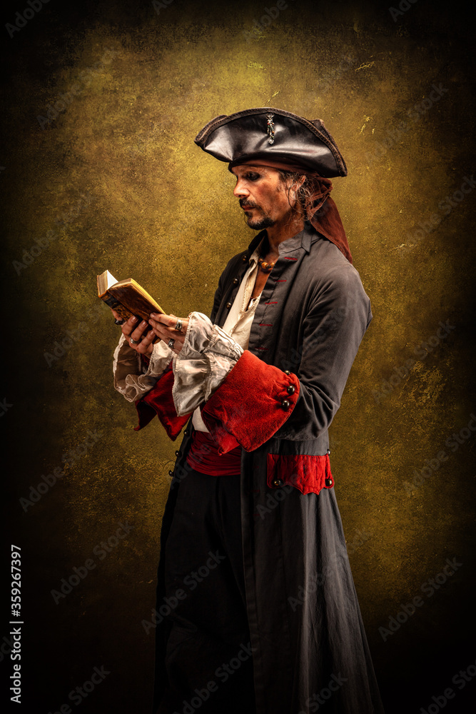 Naklejka premium Portrait of a pirate holding a book in his hands