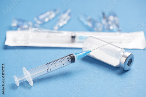Medical glass vials and syringe for vaccination. Drug or vaccine for treatment, flu in laboratory, hospital. Pharmacy concept