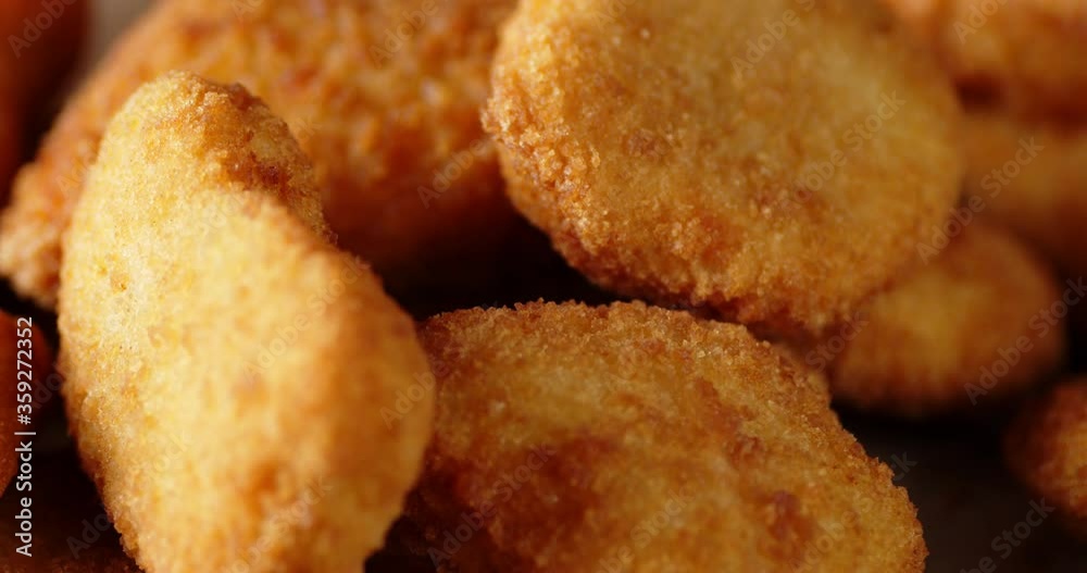 A pile of chicken nuggets rotates slowly. A pile of chicken nuggets rotates slowly.