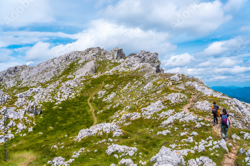 Mount Aizkorri 1523 meters, the highest in Guipuzcoa. Basque Country. Ascent through San Adrian and return through the Oltza fields. Two sisters on the trek about to reach the top happy photo