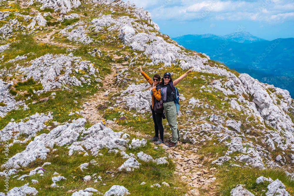 Mount Aizkorri 1523 meters, the highest in Guipuzcoa. Basque Country. Ascent through San Adrian and return through the Oltza fields. Two sisters about to reach the top happy Mount Aizkorri 1523 meters, the highest in Guipuzcoa. Basque Country. Ascent through San Adrian and return through the Oltza fields. Two sisters about to reach the top happy