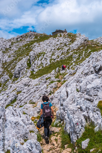 Mount Aizkorri 1523 meters, the highest in Guipuzcoa. Basque Country. Ascent through San Adrian and return through the Oltza fields. A young woman finishing the trek almost at the top