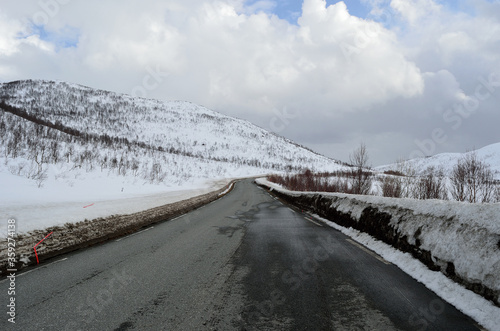 long winter road through snowy mountain landscape