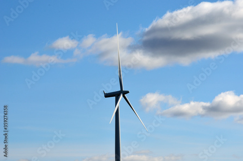 windmill on blue sky background with some clouds