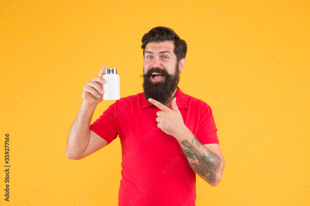 Vitamin complex. Handsome bearded man take medication. Health care. Better nutrition for better life. Investment in health. Side effects. Medicines concept. Food additives vitamins for male health Vitamin complex. Handsome bearded man take medication. Health care. Better nutrition for better life. Investment in health. Side effects. Medicines concept. Food additives vitamins for male health