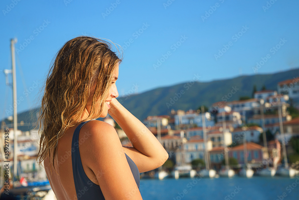 Happy young woman feels happy on the luxury sail boat yacht catamaran in turquoise sea.