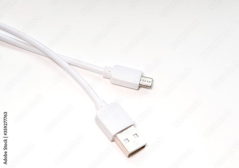 Cable for charging a mobile smartphone on a white background. selective focus Cable for charging a mobile smartphone on a white background. selective focus