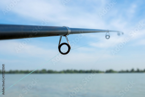 Spinning fishing rod close-up. Fishing on the lake. Fishing gear.