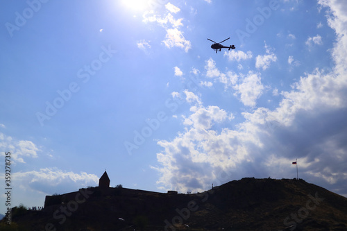 Silhouette of a Helicopter for Sightseeing Flying over Khor Virap Monastery, Town of Artashat near Armenian-Turkish Border, Armenia