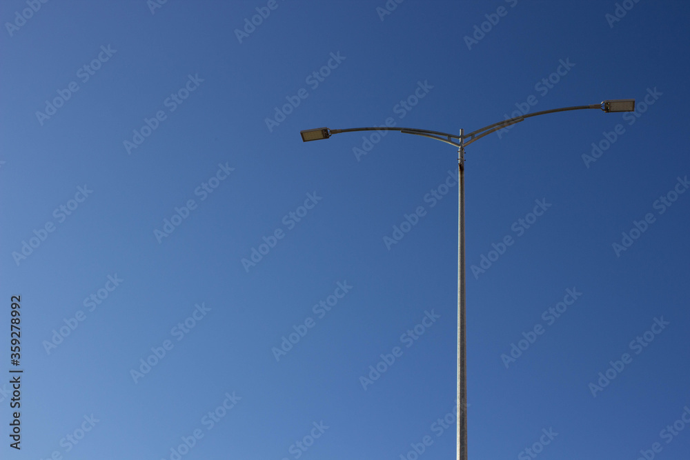 Street light against the blue sky with clouds. Copy space.