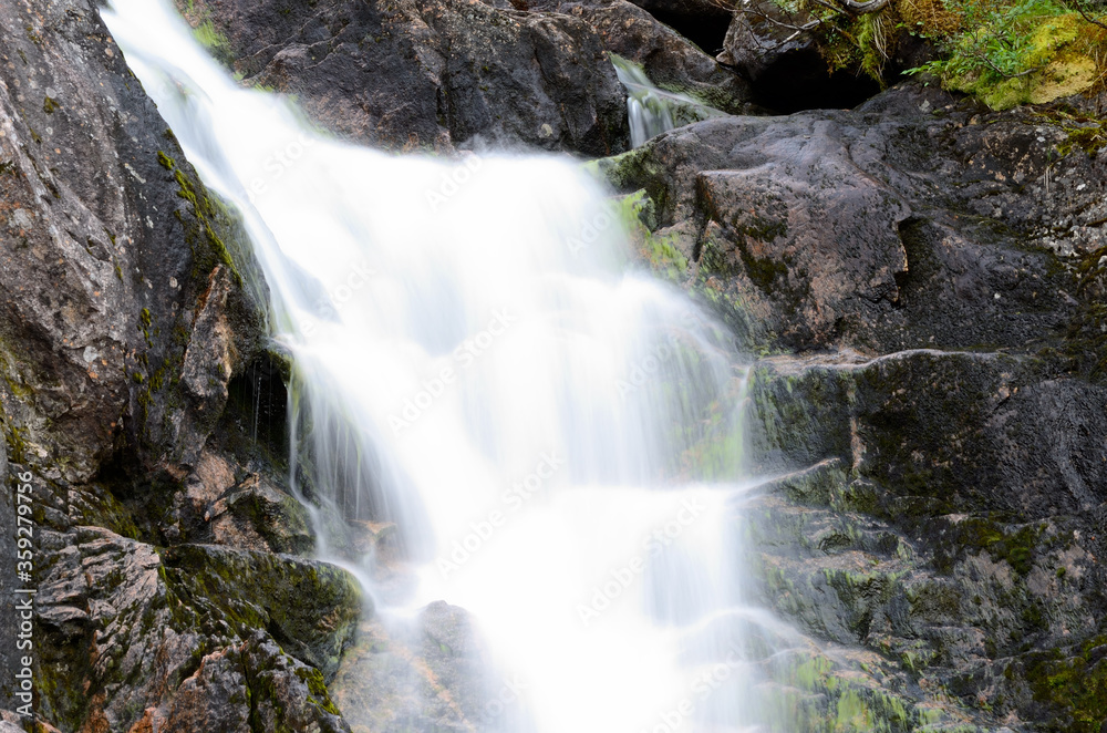 majestic small fresh water stream on mountain in summer