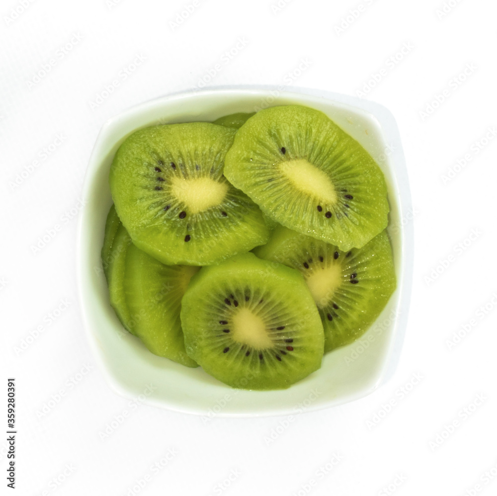 Presentation of kiwi on porcelain plate, isolated on white background. Presentation of kiwi on porcelain plate, isolated on white background.