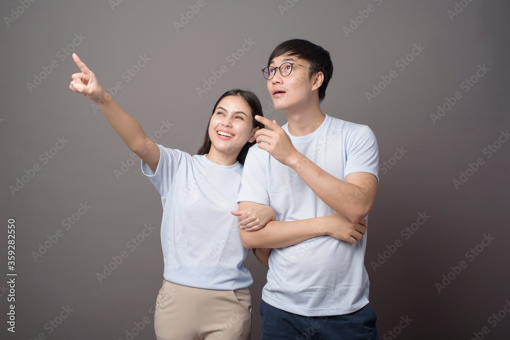 a portriat of a happy couple wearing blue shirt is enjoying over grey background studio a portriat of a happy couple wearing blue shirt is enjoying over grey background studio