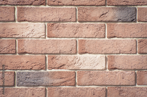 Texture of decorative bricks for finishing the facade of a house with a light brown shade