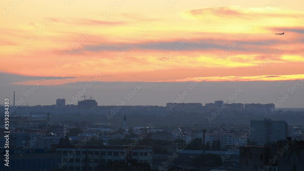The plane flies over the city of Ryazan at sunset The plane flies over the city of Ryazan at sunset