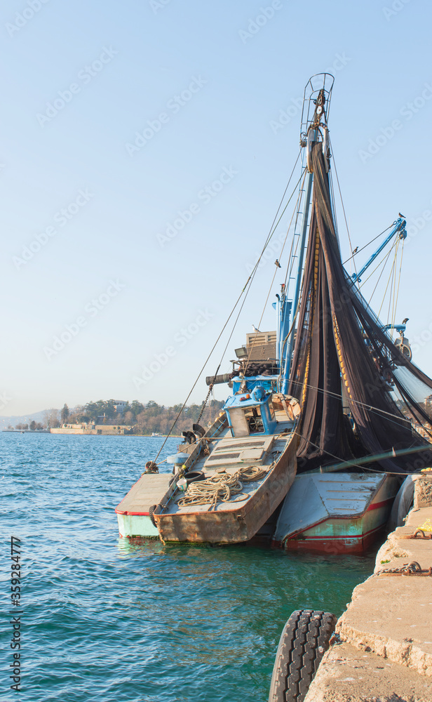 Big fishing boat on the coast of Istanbul. Big fishing boat with fishing net and small fishing boat behind it.