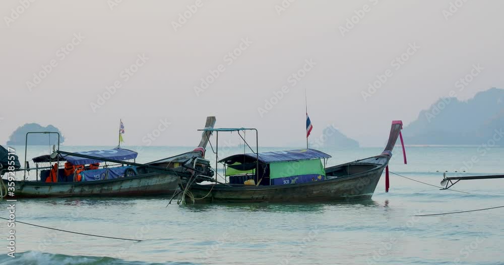 Traditional Thai long-tail boat at sunrise