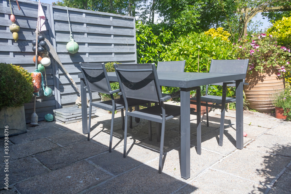 Flowered terrace with garden furniture during spring