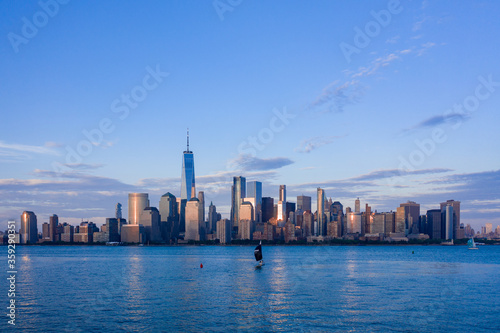 Aerial view of New York City skyline at sunset with both midtown, WTC, and downtown Manhattan