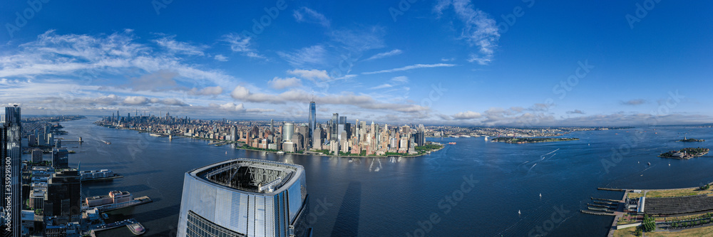 Fototapeta premium Aerial panorama of New York City skyline with both Jersey City and downtown Manhattan from Hudson River 